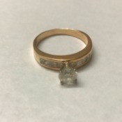 A shiny diamond and gold ring.