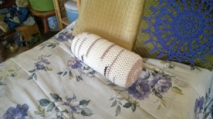 Crocheted "Timber" Neck Pillow Pattern - finished pillow on bed