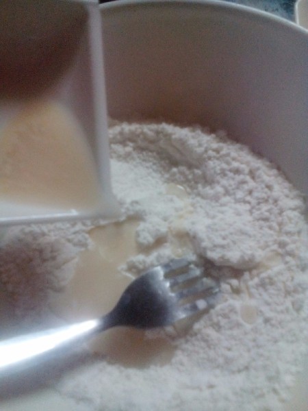 adding yeast mixture to flour