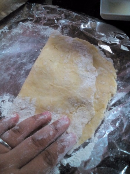 folding dough on foil