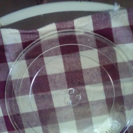 The pieces to a glass microwave tray, to be used as a lazy susan.