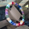 The attached multicolored crocheted steering wheel cover.