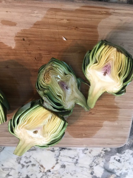 Prepared artichokes, cut in half.