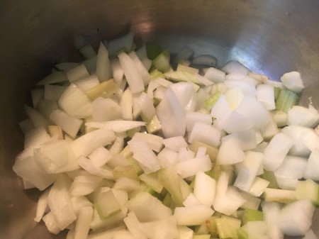 Sauteeing onions in a large pan, for making Broccoli Lemon Mint soup.