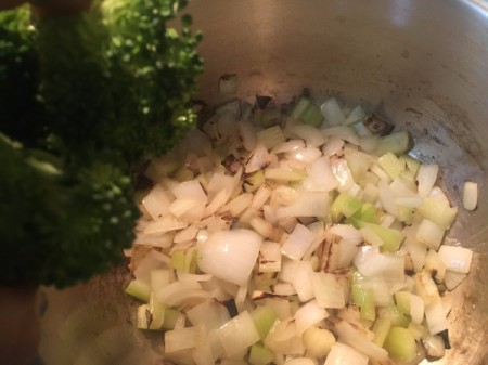 Adding broccoli to a large pan, for making Broccoli Lemon Mint soup.