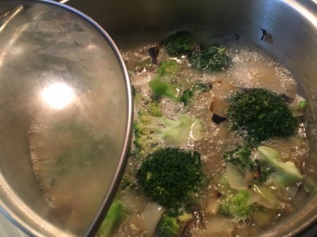 Cooking the broccoli with the onion mixture.