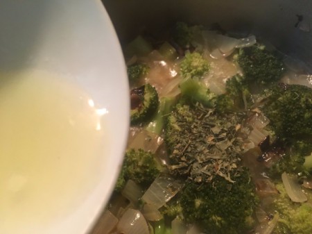 Adding lemon juice to the soup mixture.