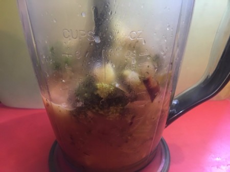 Blending the cooked soup mixture to make it creamy.