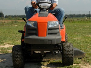 A riding mower cutting grass.