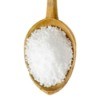 A wooden spoon full of epsom salts.