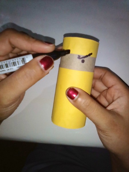 Adding eyes and eyebrows to the ninja toilet paper roll.