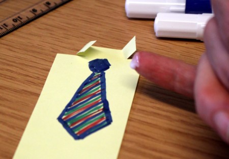 Glueing down folded paper for collar.