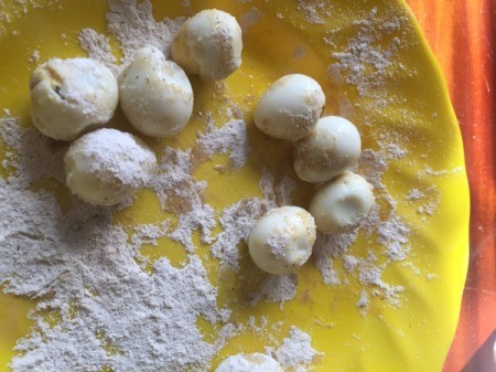 rolling Quail Eggs in flour