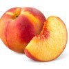 A photo of a whole peach and a peach wedge.