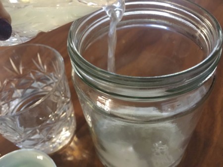 Making homemade mouthwash in a canning jar.