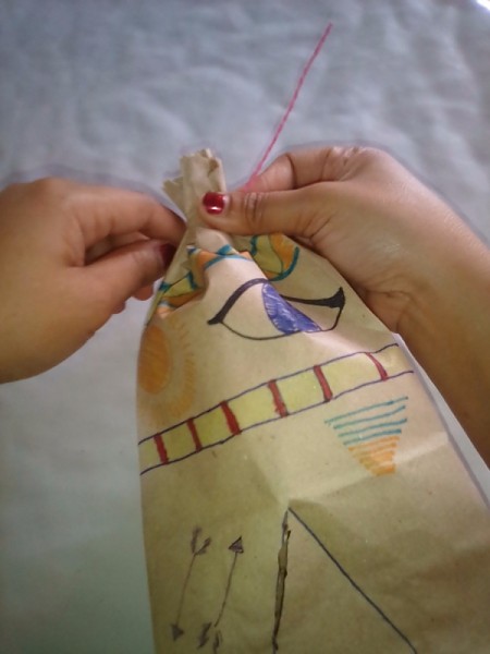 Paper Bag Tent - tying the top closed