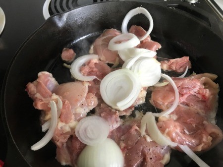 onions and chicken in skillet