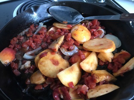 peaches, tomatoes and onions in pan