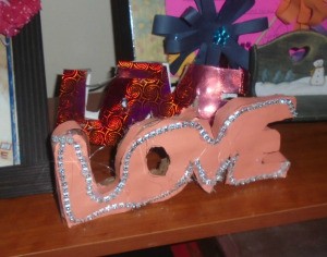 'Love' Cardboard Sign  - pink finished project displayed on a shelf