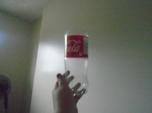 A plastic soda bottle with the top cut off.