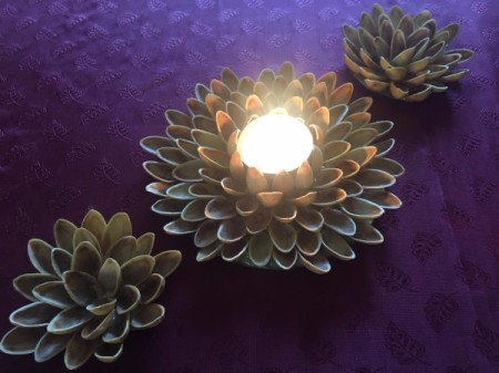 Pistachio Shell Flowers and Candle Holder - burning candle and two small flowers