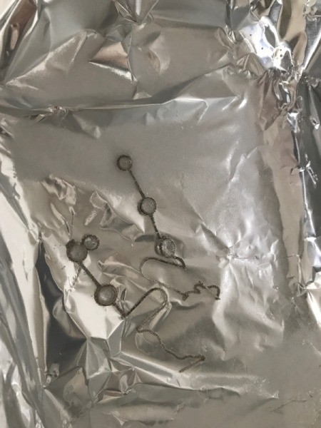 Cleaning Silver with Aluminum Foil - silver jewelry in pan
