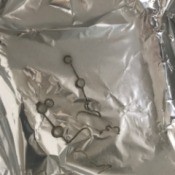 Cleaning Silver with Aluminum Foil - silver jewelry in pan