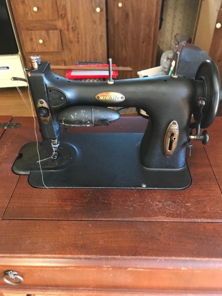 Vintage White Rotary Electric Sewing Machine - old black sewing machine in a mahogany cabient