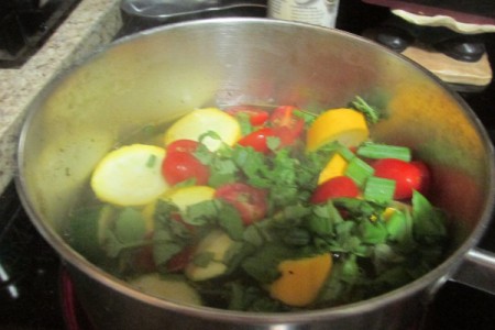 Farm grown fresh vegetables being cooked in a saucepan.