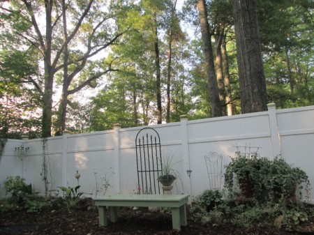 Outdoor Bench Made Easy - bench in garden near fence