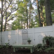 Outdoor Bench Made Easy - bench in garden near fence