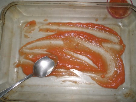 pasta sauce on bottom of baking dish