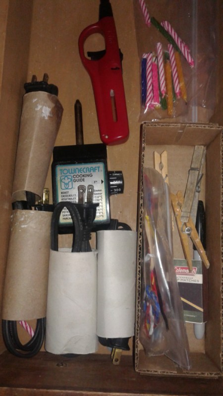 A drawer with the cords neatly stored inside cardboard tubes.