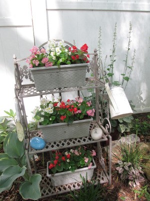Using A Baker's Rack In Your Garden - rack with pots of flowes