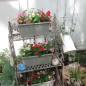 Using A Baker's Rack In Your Garden - rack with pots of flowes