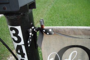 A garden flag secured by a metal clip.