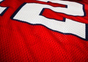 Close-up of a red and white football jersey.