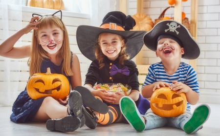 Three kids wearing cute costumes.