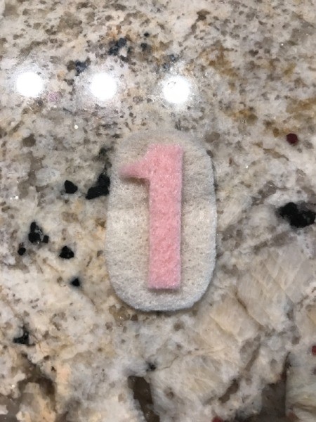 Birthday Crown - cutting felt decorations of an oval with the number 1 glued on it