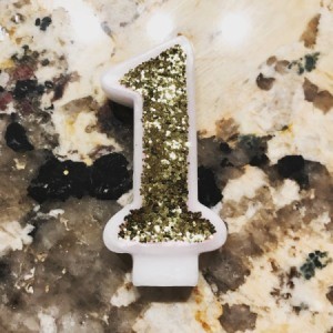 Glitter Candle - closeup of number  1 birthday candle with gold glitter