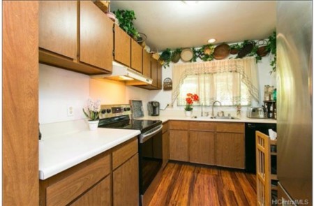 A small kitchen with wood cabinets.