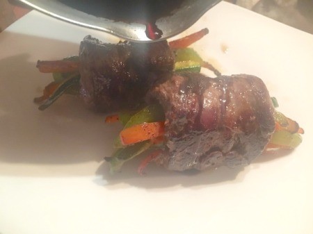 drizzling Balsamic Steak and Veggie Rolls with sauce
