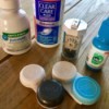 A collection of different products for caring for contact lenses.