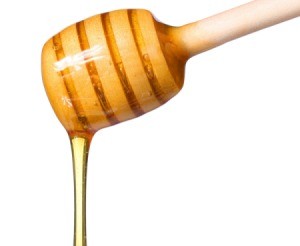 Honey dripping off of a honey dipper.