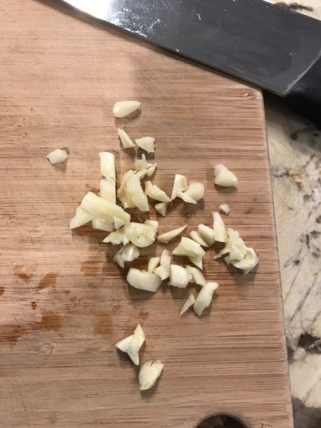 Quick Chili Dinner minced garlic on cutting board