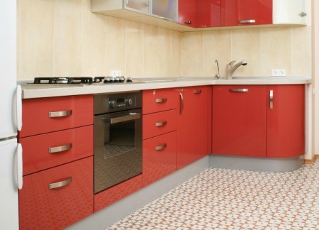 A kitchen with a vinyl floor.
