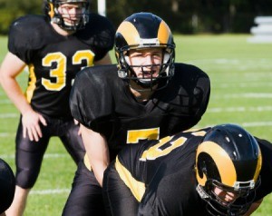 High school age kids playing football.