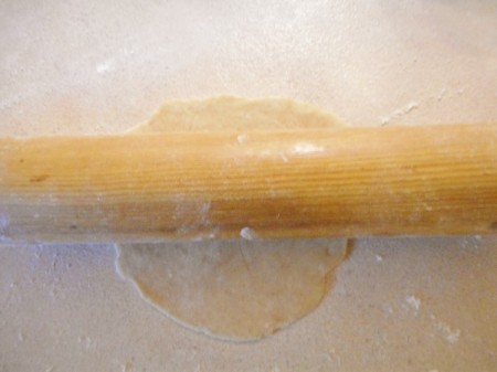 flattening tortilla with rolling pin