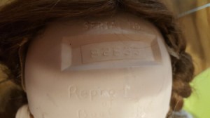 Identifying a Porcelain Doll Based on a Serial Number - number on doll's head