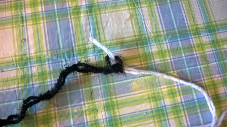 Joining two strands of yarn together.